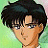 Pixelated anime-style character with dark tousled hair and glasses, set against a green-to-pink gradient background with black text reading 'Anime IM' and 'com' on the right.