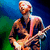 A pixelated image of a person playing an electric guitar, with visible color shifts