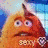 Animated orange furry creature with three eyes, wide mouth showing teeth, and a single horn on its head against blue sky background.