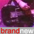 Pixelated static image with dark central shape against pink/purple gradient background and red/white text banner at bottom.
