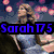 Pixelated image of a woman with long brown hair in a blue dress holding a microphone, with pink circular lights in the background.