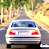 Animated contact sheet showing two frames of a silver sedan driving on a tree-lined road with
