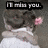 A pixelated image of a person with brown hair holding a pink flower, wearing a white top, with text above reading "I miss you.".