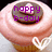 A cupcake with pink frosting and a chocolate top, featuring purple text reading 'happy b-day' on the left side.