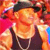 Pixelated image of a person with light skin wearing a dark sleeveless top and a dark headband, set against a vibrant red and orange background.