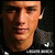 Pixelated close-up of a person's face with dark clothing against a black background, appearing as a static buddy icon.