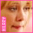 A pixelated close-up of a person's face with light brown hair, framed by pink and purple borders containing vertical text.