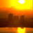 Pixelated sunset scene with bright yellow sun, orange gradient sky, dark building silhouettes, and water reflection.