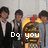 Group of people in formal attire standing behind a colorful arcade machine with text changing across frames.