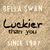 Static image with beige textured background displaying text elements including 'BELLA SWAN', 'Luckier than you', and 'SINCE 1987' in varying fonts.