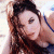 A pixelated image of a person with long brown hair and blue clothing, next to green text reading 'Original Icons .com' on a dark background.