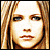 Pixelated portrait of a person with long light brown hair, blue eyes, and neutral expression across four showing red overlay changes