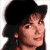 Pixelated static image of a person with brown hair wearing a black hat, viewed in profile against a white background.