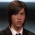 A pixelated image shows a person with brown hair wearing a dark jacket over a white shirt, next to bold black text reading "TMTH" on a white background.