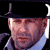Pixelated static image of a man's face wearing a black tricorn hat and light blue shirt against dark background