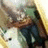 Pixelated static image of a figure in dark clothing holding a white object against a gradient background.