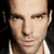 A man's face appears in three with varying background colors and facial expressions