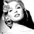 Static grayscale pixel art of a woman's face with stylized features and high-contrast shading, rendered in 48x48 pixels with dithering effects on the background.