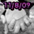 Pixelated grayscale image of a figure with indistinct features overlaid with bright pink digital date text.