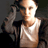 Static pixelated image of a person in a white tank top with one arm raised, set against dark background.
