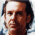 Pixelated close-up of a man's face with brown hair and light skin, rendered in low-resolution 256x256 pixels using dithering and anti-aliasing effects on a white background.