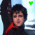 A person with dark hair in a black and red outfit raises one arm against a light blue background, with green text changing across frames.