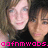 Two pixelated faces in close proximity, one with light skin and blue eyes, the other with darker skin, both wearing dark clothing against a blurred background with pink text at the bottom.