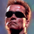 Static pixelated image of a person with short light brown hair wearing dark sunglasses and a black shirt against a gradient background.