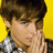 A person with brown hair and a checkered shirt covers their mouth with both hands against a yellow background.