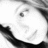 Pixelated grayscale image of a stylized face with a wide open mouth and one visible eye, set against a white background with dark curved shapes on the left and right edges.