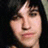 A pixelated image split into two sections: a person with dark hair on the left and a bright green background with pink text on the right.