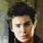 A pixelated image of a person with dark hair against a blurred background, next to pink text on blue.
