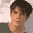 Static 48x48 pixel icon showing a close-up of a person's face with short dark hair, light skin tone, and visible facial features including eyes, nose, mouth, and cheeks against a blurred background.