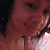 A pixelated close-up of a person's face with dark hair, showing partial features including an eye, nose, and mouth against a blurred background.