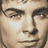Pixelated close-up of a person's face showing eyes, nose, and mouth with neutral expression and light skin tone.