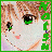 Pixelated anime-style face with green eyes, brown hair, and pink cheeks; vertical text on left side changes from green to white.