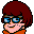 Pixel art icon of a cartoon character with red hair, blue glasses, and an orange top against gray background.