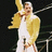 Pixelated image of a person in yellow jacket and white outfit holding microphone, with text 'Freddie 4 Ever!!!' on black background.