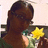 A pixelated image shows a person with long dark hair holding a yellow star-shaped object against a light background.
