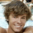 Pixelated image of a smiling person with brown hair on left, cyan background with purple text reading 'I Luv Ryan' and 'Checkler!' on right.