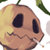 Pixelated cartoon skull with yellow and brown tones, dark eye sockets, visible teeth, green stem-like protrusion on top, and partial white background elements.