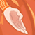 Pixelated static icon of a light pinkish-white object with an irregular shape against an orange background, featuring pixelated edges and dithering effects.