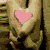 Animated sequence showing multiple heart-shaped icons: hands holding pink heart, green heart on grass, wire heart, white heart on rainbow, wooden heart with microphone, and heart with 'so in love' text.