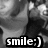 Black-and-white pixelated image of a person's face with a smiley text overlay at the bottom.