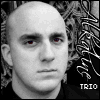 Black-and-white image of a bald person with red eyes against a patterned background, showing text variations below the face.