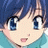 A pixelated anime-style character face with blue hair and large eyes on the left, next to a black background with white text reading "Anime IM" and "COM" on the right.