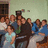 Group of people in a room with green walls and wooden furniture, blue text reading 'I <3 My Friends' on white background