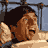 A 3x3 contact sheet of a pixelated animated sequence showing a man in various poses with exaggerated facial expressions and body movements, set against a blue background with metal bars.