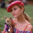 A pixelated image of a woman in a red beret holding a small dog, with pink text reading 'and we're both gemini vegetarians' on white and gray backgrounds.
