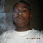 Pixelated static image of a person with dark skin wearing a white shirt against a gradient background.